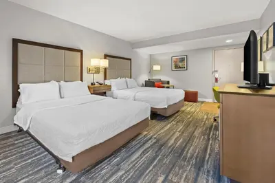a hotel room with two beds and a flat screen tv at Hampton Inn Toledo-South/Maumee in Maumee