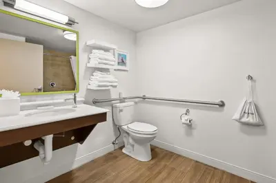 a bathroom with a toilet and a sink and a mirror at Hampton Inn Toledo-South/Maumee in Maumee