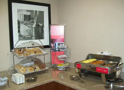 a counter with a bunch of donuts on it at Hampton Inn Gallipolis in Gallipolis