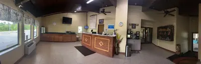 a restaurant with a bar in the middle of a room at Executive Inn in Zanesville