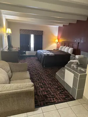 a hotel room with a bed and a couch at Executive Inn in Zanesville