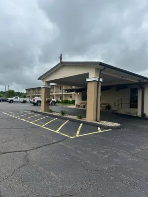a building with a parking lot in front of it at Executive Inn in Zanesville