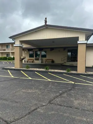 a parking lot in front of a building at Executive Inn in Zanesville