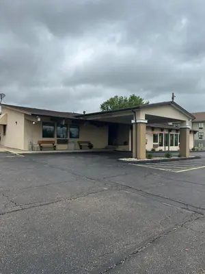 a building with a parking lot in front of it at Executive Inn in Zanesville
