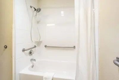 a bathroom with a shower and a white tub at Quality Inn & Suites Florence - Cincinnati South in Florence