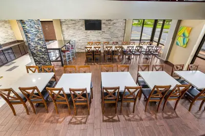 an empty dining room with tables and chairs at Quality Inn & Suites Florence - Cincinnati South in Florence