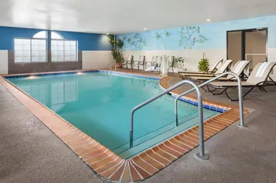 a pool in a hotel room with chairs around it at Country Inn & Suites by Radisson, Lexington, KY in Lexington