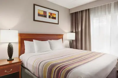 a hotel room with a bed and a window at Country Inn & Suites by Radisson, Lexington, KY in Lexington