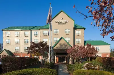 a building with a flag in front of it at Country Inn & Suites by Radisson, Lexington, KY in Lexington