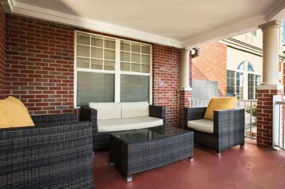 a patio with wicker chairs and a table at Country Inn & Suites by Radisson, Lexington, KY in Lexington