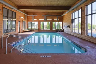 a swimming pool in a house with windows at Comfort Inn & Suites Toledo North in Toledo