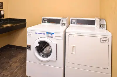 a washing machine and a dryer in a room at Comfort Inn & Suites Toledo North in Toledo