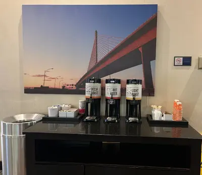 a counter with three bottles of coffee on it with a bridge at Comfort Inn & Suites Toledo North in Toledo