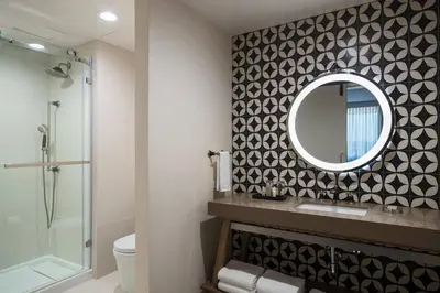 a bathroom with a mirror and a shower at Renaissance Columbus Westerville-Polaris Hotel in Westerville