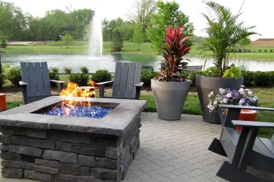 a stone fire pit with two chairs and a fountain at Renaissance Columbus Westerville-Polaris Hotel in Westerville
