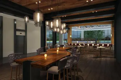 a dining room with a long wooden table and chairs at Renaissance Columbus Westerville-Polaris Hotel in Westerville