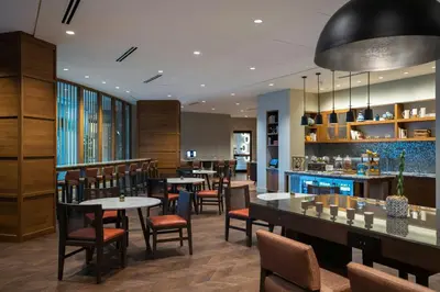 a restaurant with tables and chairs and a bar at Renaissance Columbus Westerville-Polaris Hotel in Westerville
