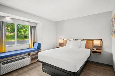a hotel room with a bed and a window at Microtel Inn by Wyndham Lexington in Lexington