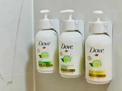 three bottles of adore bathroom cleaner on a shelf at Microtel Inn by Wyndham Lexington in Lexington