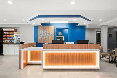 a lobby of a store with a blue wall at Microtel Inn by Wyndham Lexington in Lexington