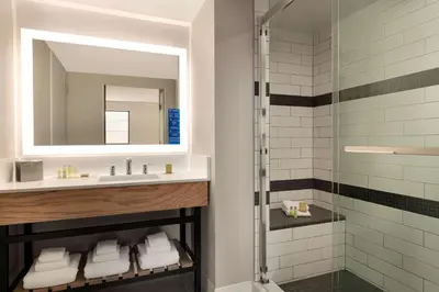 a bathroom with a sink and a shower at DoubleTree by Hilton Canton Downtown in Canton