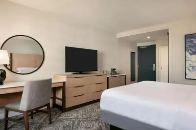 a hotel room with a bed and a desk with a television at DoubleTree by Hilton Canton Downtown in Canton