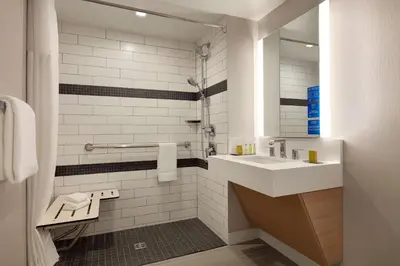 a bathroom with a sink and a mirror at DoubleTree by Hilton Canton Downtown in Canton