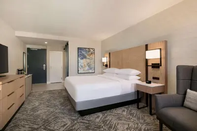 a hotel room with a large white bed and a couch at DoubleTree by Hilton Canton Downtown in Canton