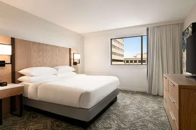 a hotel room with a large bed and a window at DoubleTree by Hilton Canton Downtown in Canton