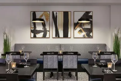 a dining room with four tables with wine glasses at DoubleTree by Hilton Canton Downtown in Canton