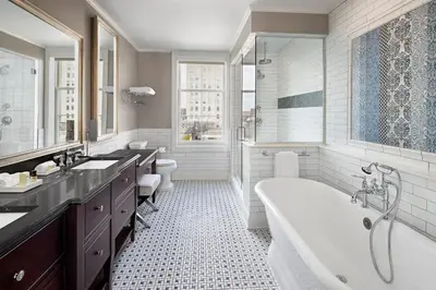a bathroom with two sinks and a tub and a shower at The Hancock Hotel in Findlay