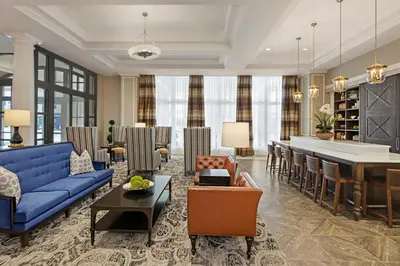 a living room with a blue couch and a table at The Hancock Hotel in Findlay