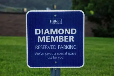 a blue sign in front of a grass field at Hampton Inn Ashland in Ashland