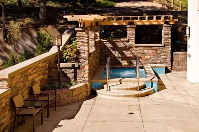 a swimming pool in a house with a stone wall at Hampton Inn Wheeling in Wheeling
