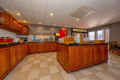a large kitchen with wooden cabinets in a restaurant at Hampton Inn Wheeling in Wheeling