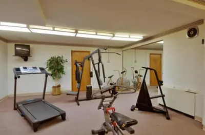 a gym with several exercise bikes in a room at Travelodge by Wyndham Cleveland Airport in Brook Park