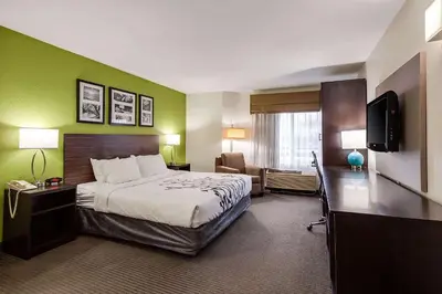 a hotel room with a bed and a flat screen tv at Baymont by Wyndham Milan in Milan