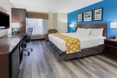 a hotel room with a bed and a desk at Baymont by Wyndham Milan in Milan