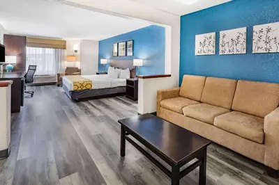 a hotel room with a couch and a bed at Baymont by Wyndham Milan in Milan