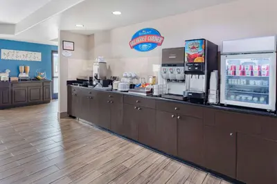a fast food restaurant with a counter with a refrigerator at Baymont by Wyndham Milan in Milan