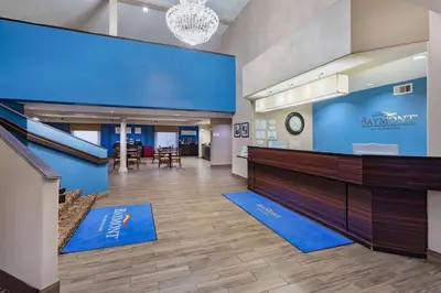 a lobby of aaz mart with a blue wall at Baymont by Wyndham Milan in Milan