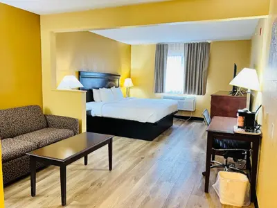 a hotel room with a bed and a couch at Econo Lodge Inn & Suites Monroe in Monroe