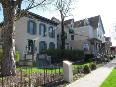 a house with a fence in front of it at Historic LaSalle Downtown in Fort Wayne