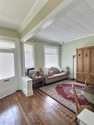 a living room with a couch and a table at Historic LaSalle Downtown in Fort Wayne