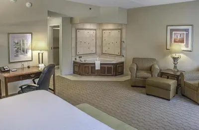 a hotel room with a bed and a tub at Hampton Inn & Suites Youngstown-Canfield in Canfield