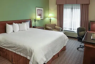 a hotel room with a large bed and a window at Hampton Inn & Suites Youngstown-Canfield in Canfield
