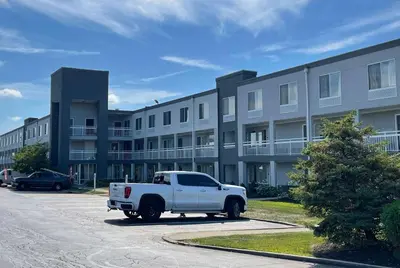 a white truck parked in front of a building at Baymont by Wyndham Dayton North in Dayton