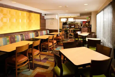 a restaurant with tables and chairs and a bar at Baymont by Wyndham Dayton North in Dayton