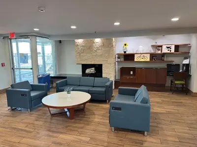 a lobby with couches and a table and a fireplace at Baymont by Wyndham Dayton North in Dayton