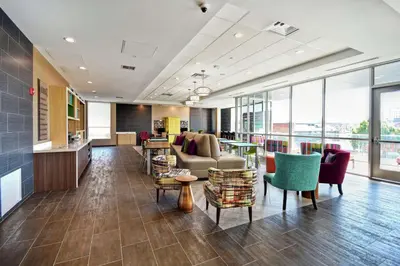 a lobby with a couch and tables and chairs at Home2 Suites By Hilton Columbus Downtown in Columbus
